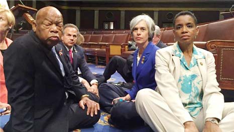 The sit-in was led by Democrat Representative John Lewis (centre).