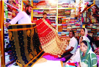 KHULNA: Shop keepers are passing busy time at Sarwardi market in Boro Bazar. This picture was taken on Wednesday.