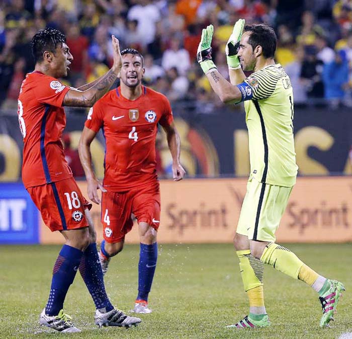 Chile goalkeeper Claudio Bravo (1), right celebrates with and Chile's Mauricio Isla (4) and other players during a Copa America Centenario semifinal soccer match at Soldier Field in Chicago on Wednesday. Chile won 2-0.