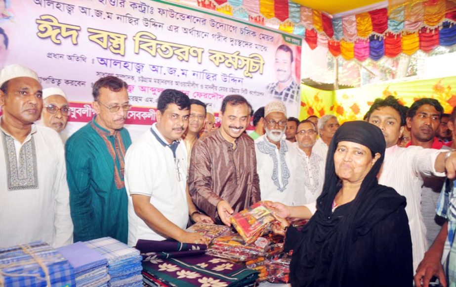 CCC Mayor A J M Nasir Uddin distributing Eid clothes among the poor people assisted by MA Sattar Contactor Foundation at Uttar Pathantoli area on Wednesday.