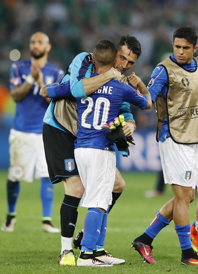 Italy's goalkeeper Gianluigi Buffon (center) hugs teammate Lorenzo Insigne at the end of the Euro 2016 Group E soccer match between Italy and Ireland at the Pierre Mauroy stadium in Villeneuve d'Ascq, near Lille, France on Wednesday.