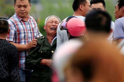 A family member of a victim cries after a tornado hit Funing on Thursday, in Yancheng, Jiangsu province