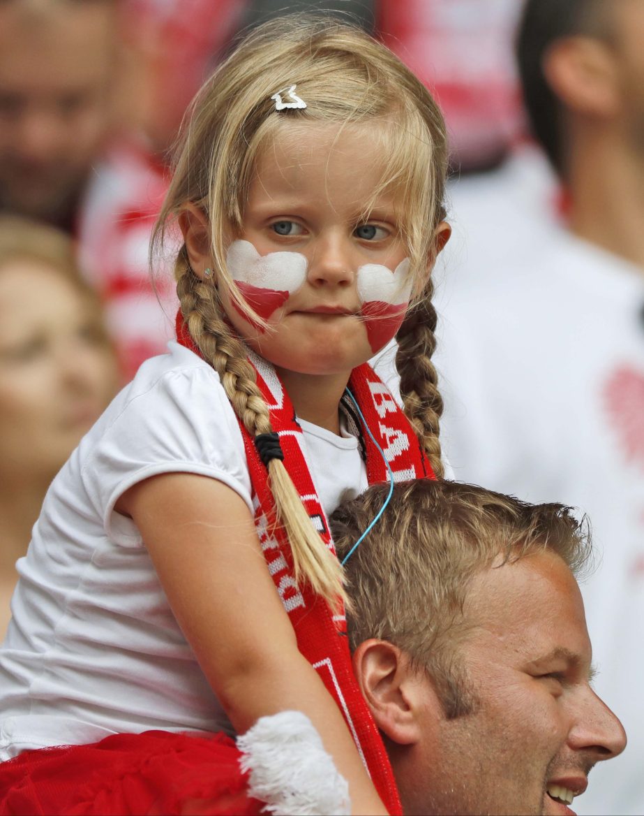 A young Polish supporter is carried shoulders high as she waits for the start of the Euro 2016 round of 16 soccer match between Switzerland and Poland, at the Geoffroy Guichard stadium in Saint-Etienne, France, Saturday.