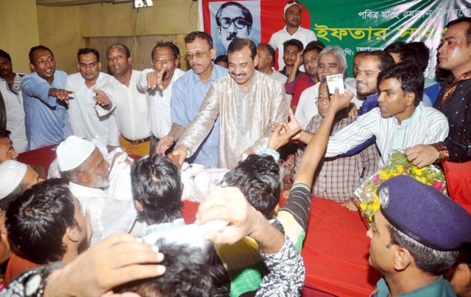 CCC Mayor AJM Nasir Uddin distributing Iftar items among the distressed people organised by Bangabandhu Parishad yesterday.