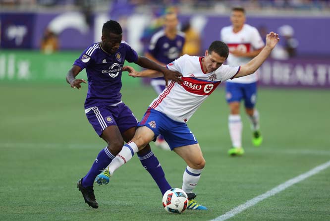 Orlando City midfielder Kevin Molino (left) and Toronto FC Midfielder Will Johnson (7) fight for the ball during an MLS soccer game in Orlando, Fla on Saturday.
