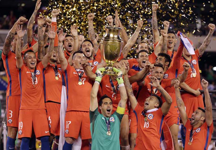 Chile goalkeeper Claudio Bravo and his teammates celebrate with their trophy after the Copa America Centenario championship soccer match in East Rutherford, N.J.on Sunday. Chile defeated Argentina 4-2 in penalty kicks to win the championship.