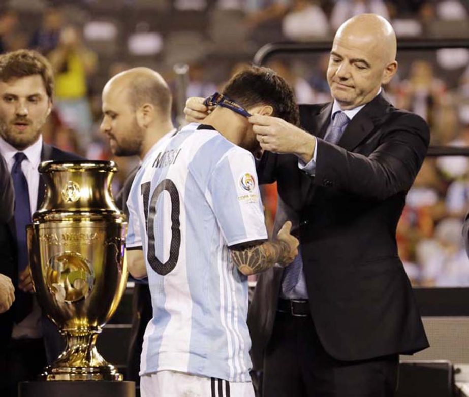 Argentina's Lionel Messi receives his medal during trophy presentations after the Copa America Centenario championship soccer match in East Rutherford, N.J. on Sunday.