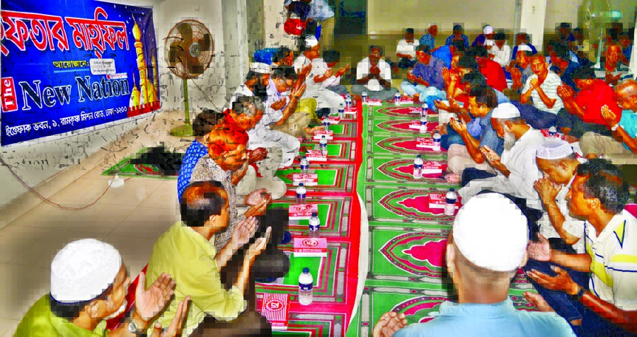 Journalists, officials and employees of The New Nation offering munajat at an Iftar Mahfil organised jointly by Dhaka Union of Journalists and Sramik-Karmachari Union of The New Nation unit at Ittefaq Bhaban in the city on Wednesday.