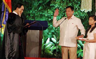 New Philippine President Rodrigo Duterte takes the oath during the inauguration ceremony in Malacanang Palace on Thursday in Manila, Philippines.