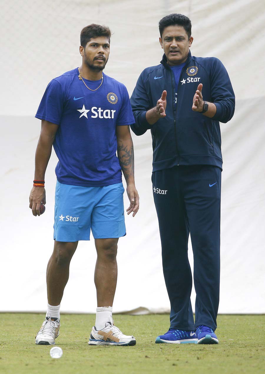 Indian cricket team head coach Anil Kumble (right) gives tips to Umesh Yadav in the nets during a training camp at National Cricket Academy in Bangalore, India on Thursday. Indian team is scheduled to travel to West Indies' to play four-match Test series