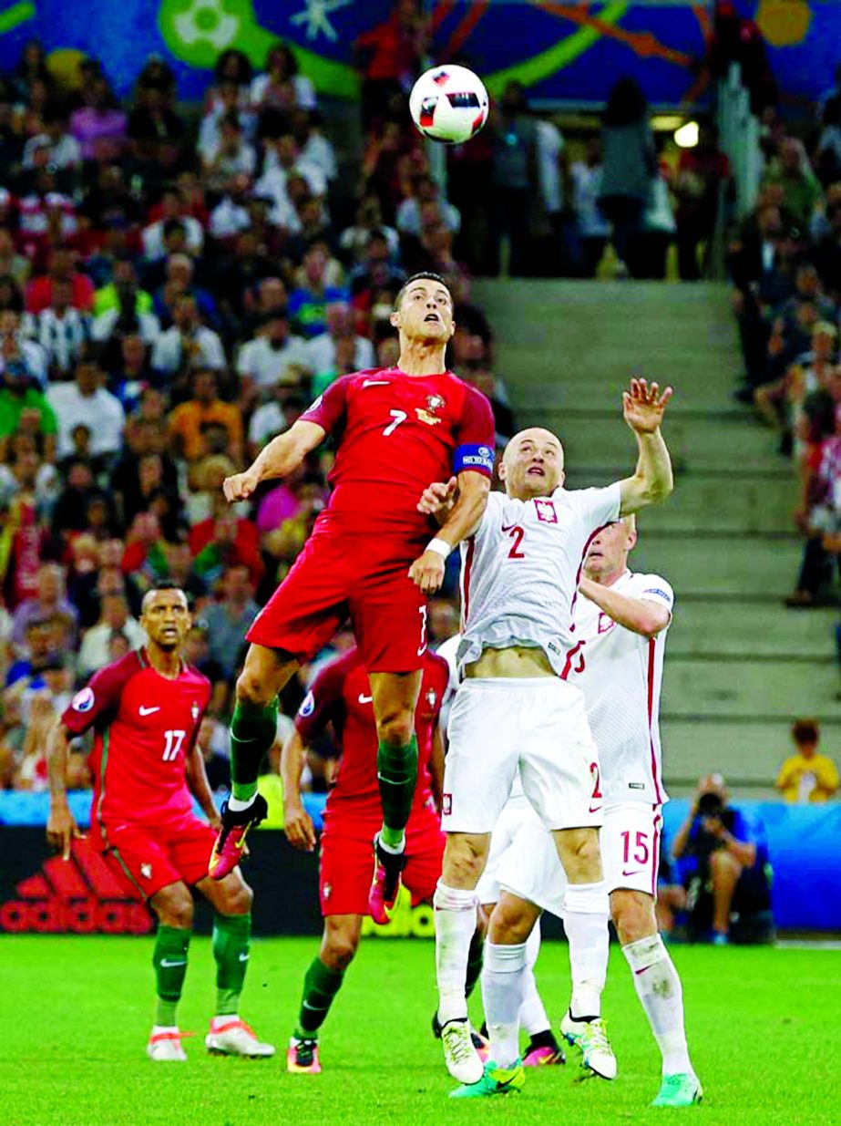 Portugal's Cristiano Ronaldo (left) jumps for the ball with Poland's Michal Pazdan during the Euro 2016 quarterfinal soccer match between Poland and Portugal, at the Velodrome stadium in Marseille, France on Thursday.
