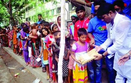 Councillor of 26 No Ward of DSCC Hasibur Rahman Manik distributing Eid clothes among the destitute in the city's Azimpur area on Saturday.