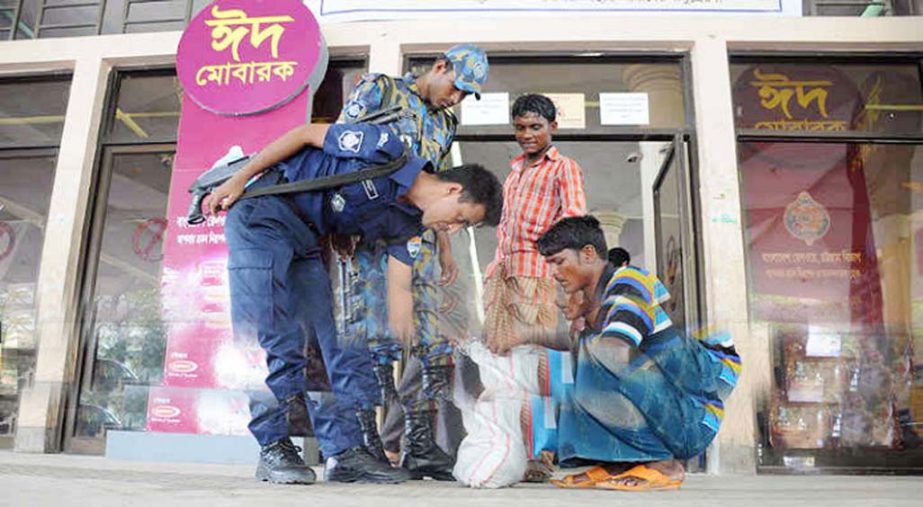 Members of the law enforcing agencies checking the luggage of the commuters of trains in front of the Chittagong Railway Station premises yesterday.