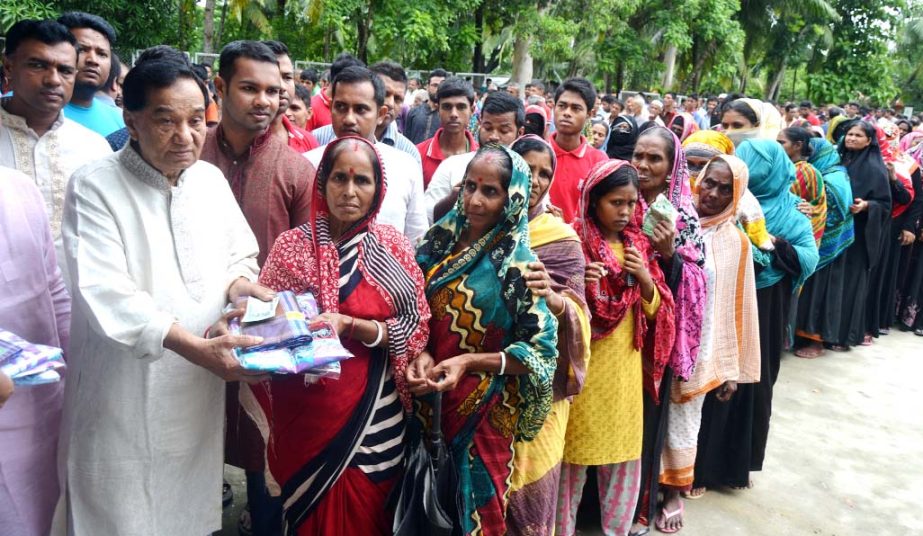 Khalilur Rahman, President, Chittagong Metropolitan Chamber of Commerce and Industry and Chairman of KDA Group distributing Eid clothes and cash among the poor at Patiya on Saturday.