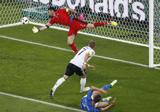 Italy goalkeeper Gianluigi Buffon saves on an attempt to score by Germany's Bastian Schweinsteiger, center, during the Euro 2016 quarterfinal soccer match between Germany and Italy, at the Nouveau Stade in Bordeaux, France on Saturday.