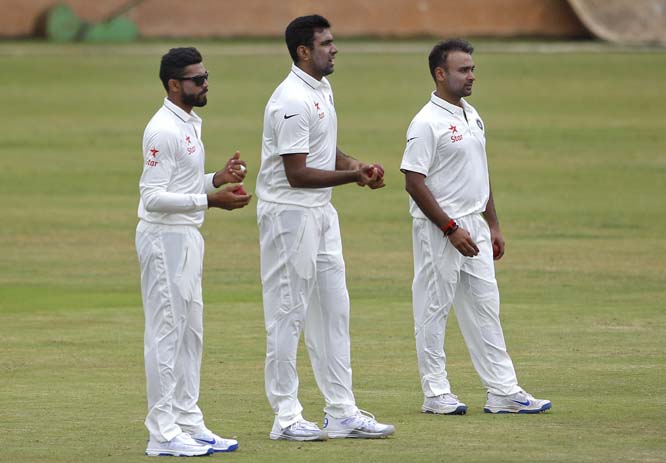 Indian cricketers Ravindra Jadeja (left) Ravichandran Ashwin (center) and Amit Mishra wait to bowl in a friendly match during team's training camp in the outskirts of Bangalore, India on Sunday. Indian team is scheduled to travel to West Indies to play f