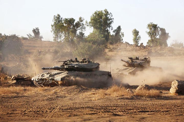 Israeli tanks maneuver during a military exercise in the Israeli-annexed Golan Heights near the border with Syria.