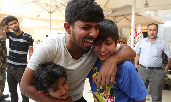 Mourners react during a funeral of a victim who was killed in a suicide car bomb in the Karrade shopping area in Baghdad.