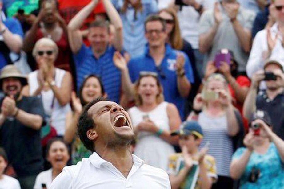 France's Jo-Wilfried Tsonga celebrates winning his match against USA's John Isner in the men's singles at the 2016 Wimbledon Championships in Wimbledon, southeast London on Sunday.