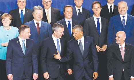 US President Barack Obama (front row, centre right) speaks to NATO Secretary General Jens Stoltenberg during the NATO Summit in Warsaw on Friday.