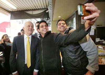 Australian Prime Minister Malcolm Turnbull (L) poses for a selfie during a street walk in Melbourne's outer east, Australia.