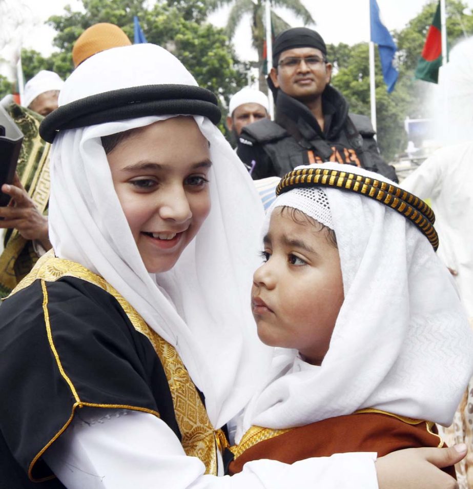 Photo shows two kids embracing each other at Jatiya Eidgah ground in the city on Thursday on the occasion of holy Eid-ul-Fitr.