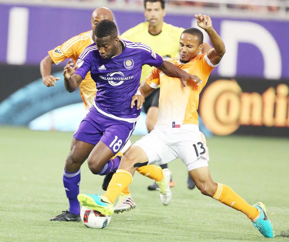 Orlando City's Kevin Molino (18) and Houston Dynamo's Ricardo Clark (13) battle for the ball during an MLS soccer game in Orlando, Fla. on Friday.