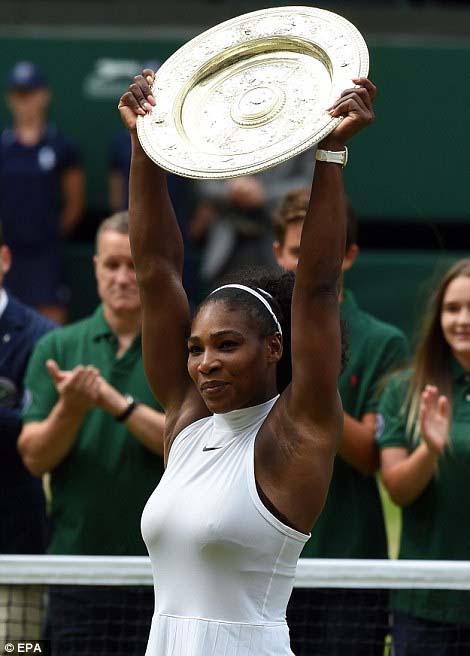 Serena lifts the Venus Rosewater Dish high as she celebrates another Wimbledon triumph on Saturday.