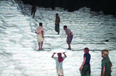 JHENAIDAH: Day-labourerers working in a mills godown where thousand tonnes of sugar lying unsold in Mobarakganj Sugar Mills Limited.