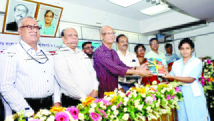 Education Minister Nurul Islam Nahid distributing English and Bengali text books among the Intermediate Students at NCTB auditorium in the city yesterday.
