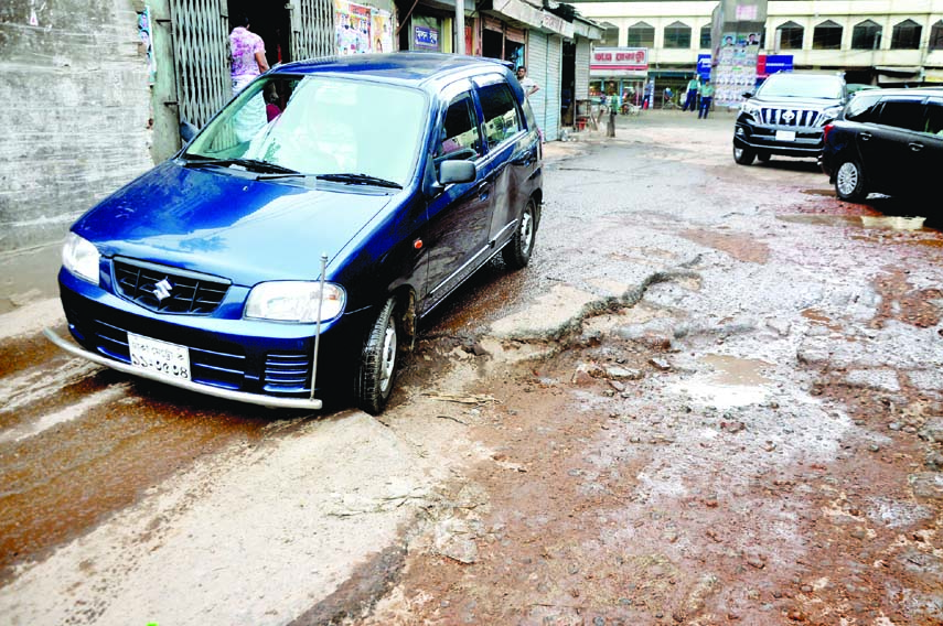 Motorised vehicles struggle through the pothole strewn road though it was repaired a few days back. The snap was taken from in front of Joykali Mandir in the city on Monday.