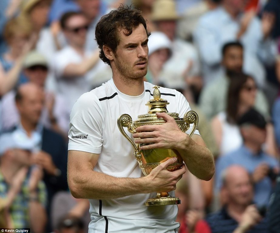 Murray hugs the trophy after becoming the first British man to win multiple Wimbledon singles titles since Fred Perry in 1935.