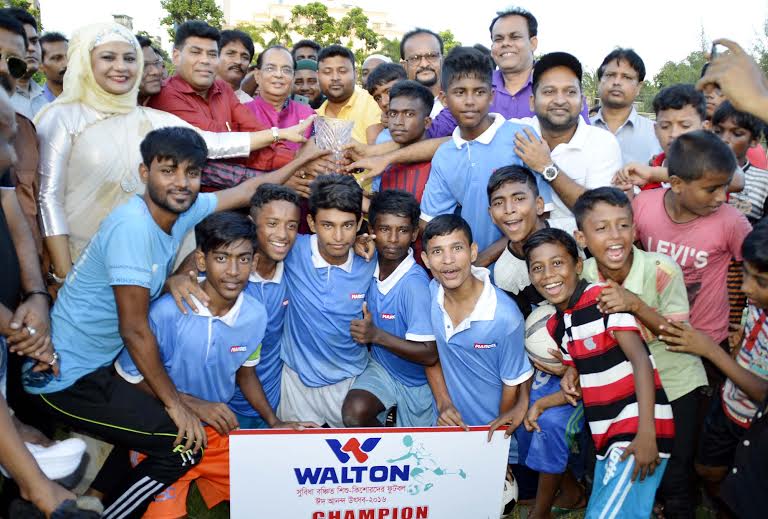 Arambagh Football Academy, the champions of the Walton Eid Football Festival for under privileged children and the chief guest State Minister for Youth and Sports Biren Shikder, the officials of Walton, the officials of Sports Lovers Association pose for