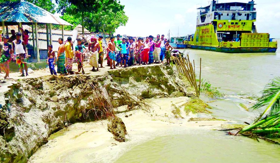 A large portion of Padma erosion engulfs the whole area of Doulatdia ferry ghat and thousands of houses and crops at Goalanda of Rajbari due to onrush of upstream waters. This photo was taken on Tuesday.