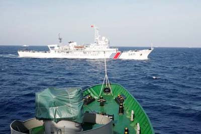 A ship (top) of the Chinese Coast Guard is seen near a ship of the Vietnam Marine Guard in the South China Sea, about 210 km (130 miles) off shore of Vietnam .