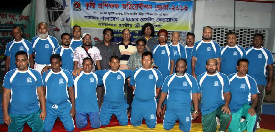 The participants of the wrestling coaches' course and the officials of Bangladesh Amateur Wrestling Federation pose for a photo session at the Gymnasium of National Sports Council on Thursday.