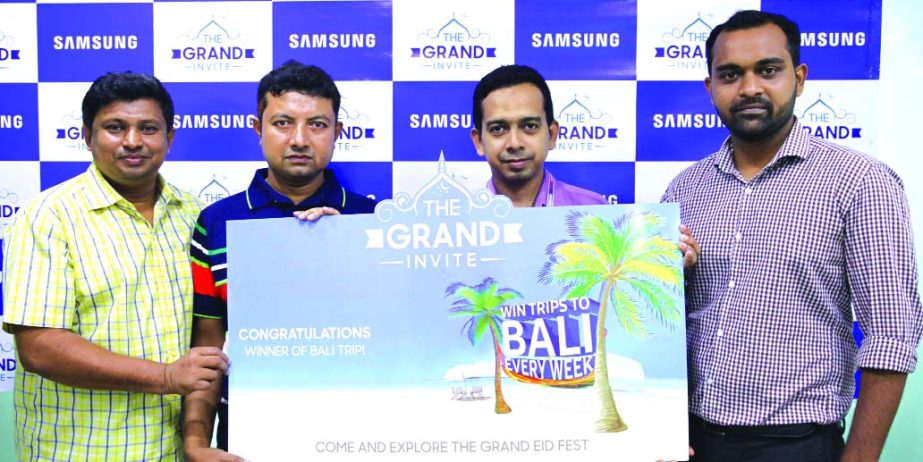 Md. Syful Islam, Manager, Consumer Electronics, Samsung Electronics Bangladesh and Saimun Sanjid Choudhury, Product Manager, Rangs Industries Limited on Thursday handing over the prize mnemonic to Muzammel Huqe, the third week's winner of Samsung's meg
