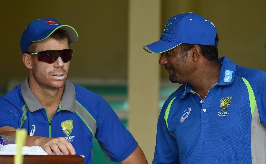 Australian cricketer David Warner (L) speaks with Australia's bowling consultant, Sri Lankan former cricketer Muttiah Muralitharan during a practice session at the P Sara Oval Cricket Stadium in Colombo on Thursday.
