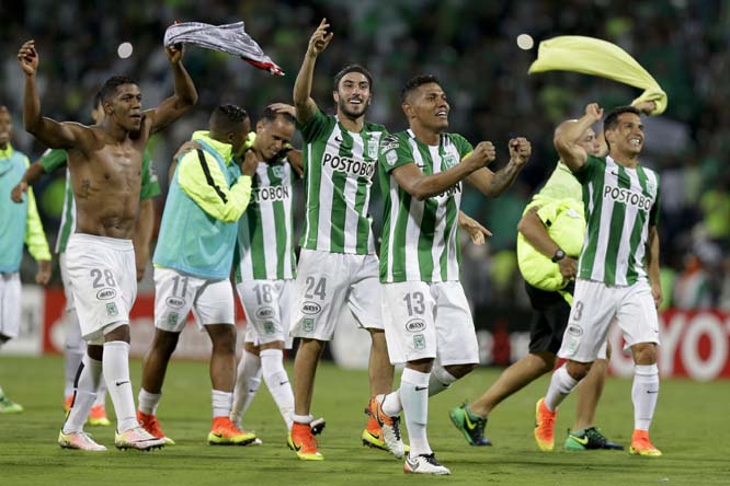 Players of Colombia's Atletico Nacional, from right to left, Felipe Aguilar, Alexander Mejia, Sebastian Perez, Alejandro Guerra, Andres Ibarguen and Orlando Berrio celebrate after beating 2-1 Brazil's Sao Paulo FC during a Copa Libertadores semifinal se