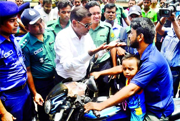 Bridge and Road Transport Minister Obaidul Quader on Thursday inspected city's Babubazar area. He stopped a biker who was riding without helmet with his minor child. The Minister warned the biker to use helmet. He also warned him not to ride with childre