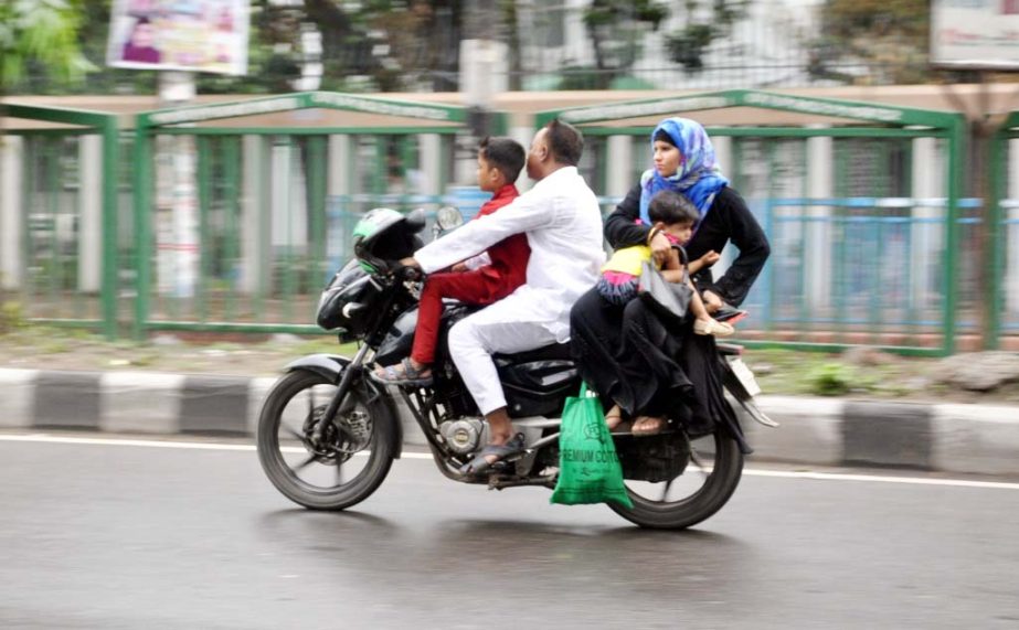 Photo shows a motor biker driving his motorbike with babies though it is prohibited. The snap was taken from the city's Topkhana Road on Friday.