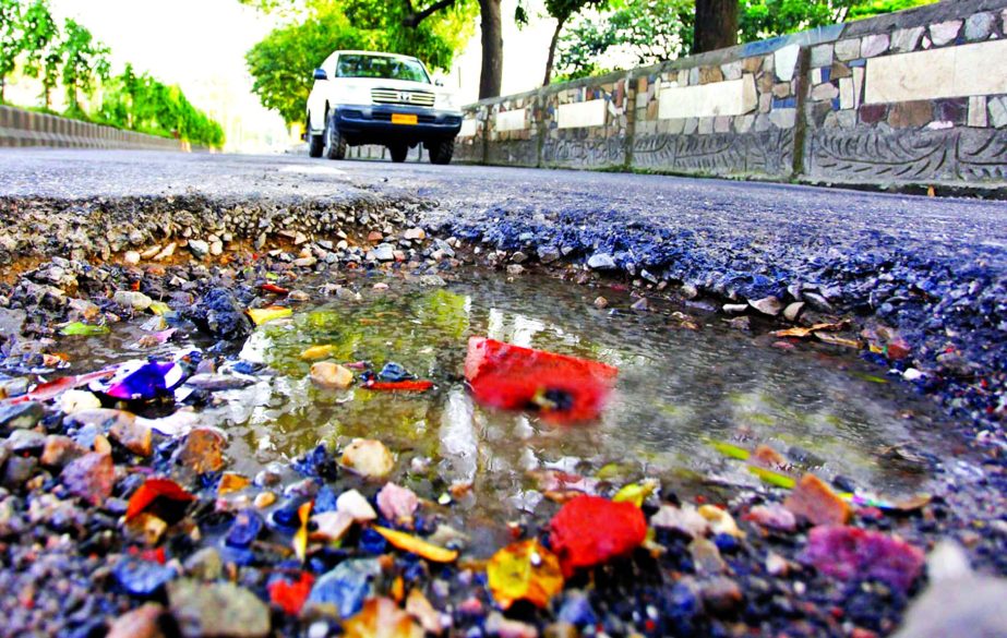 Link road in city's Agargaon area in a sorry state as potholes being developed creating difficulties for plying of vehicles and may occur accidents anytime, but the authority concerned did not pay and heed to it. This photo was taken on Friday.