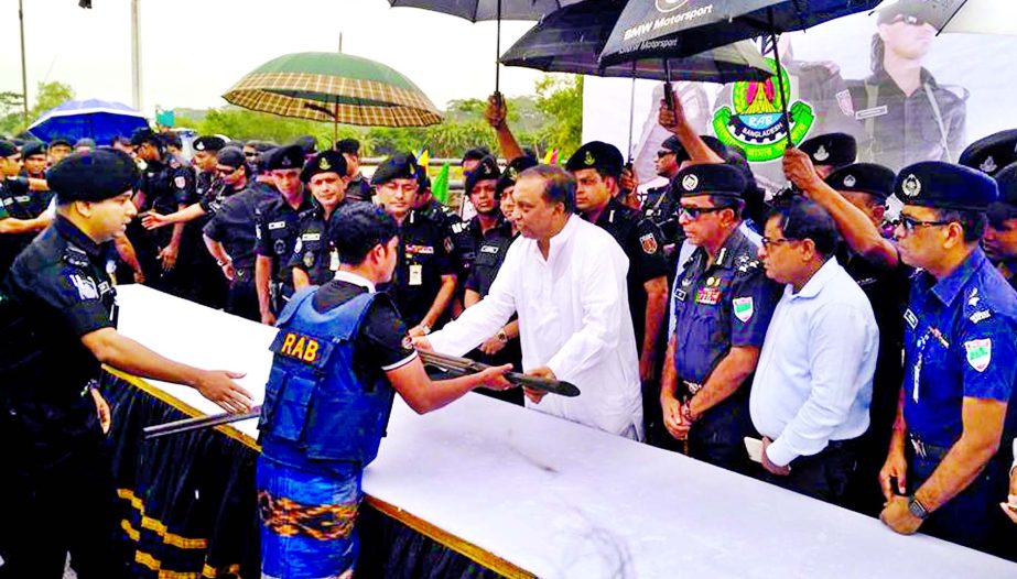 11 members of Sundarbans based robber gangs Majnu and Ilyas Bahini surrendered to Home Minister Assaduzzaman Khan with arms at Mongla Port in Khulna on Thursday.