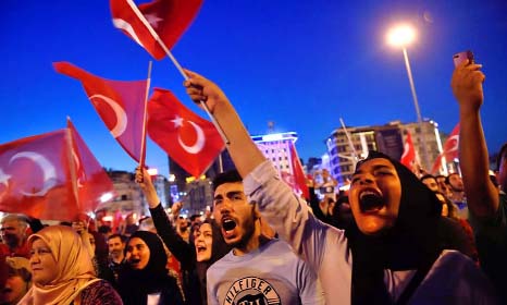 People shout in Istamabul on Saturday during a demonstration in support of Turkish President.