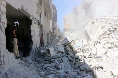 Collapsed buildings following reported air strikes in Aleppo's rebel-held neighbourhood of Tariq al-Bab.