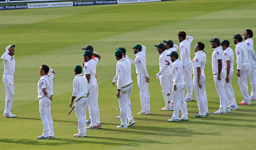 Salute to victory: Pakistan mark their winning moment against England in 1st Investec Test at Lord's on Sunday.