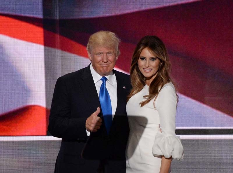 Presumptive Republican presidential candidate Donald Trump stands on stage with his wife Melania Trump following her address to delegates at the Republican National Convention in Cleveland, Ohio on Monday.