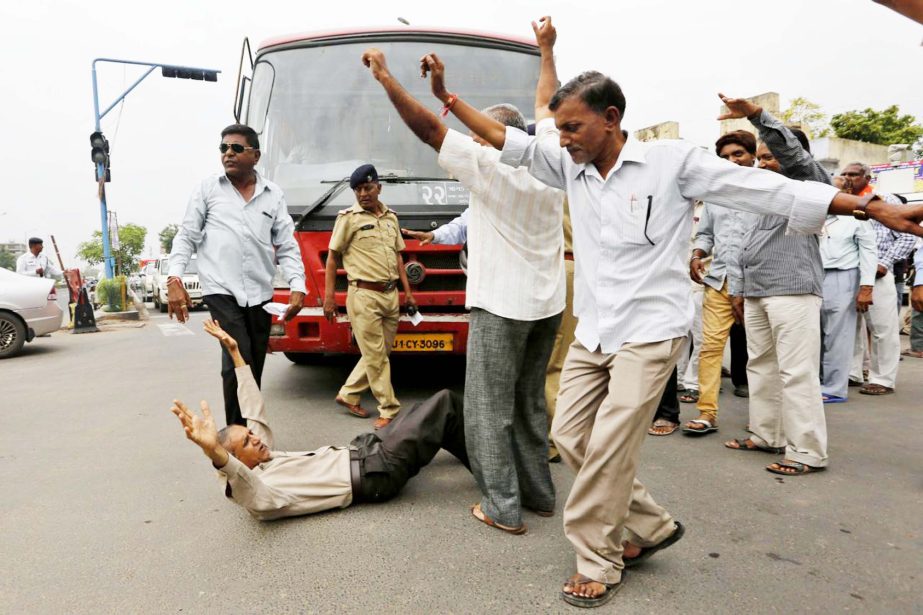 Members of India's low-caste Dalit community block traffic and shout slogans in Ahmadabad, India, on Wednesday. They were protesting after four men belonging to the Dalit community were beaten while trying to skin a dead cow in western India.