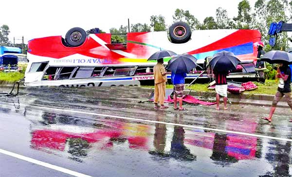 Three passengers were killed and 10 others injured as driver of Chittagong-bound bus from Dhaka lost control of it on the highway at Sitakunda and rolled over on road divider. This photo was taken on Wednesday.