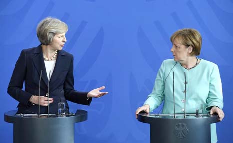 British Prime Minister Theresa May and German Chancellor Angela Merkel addressing press conference in Berlin on Wednesday.